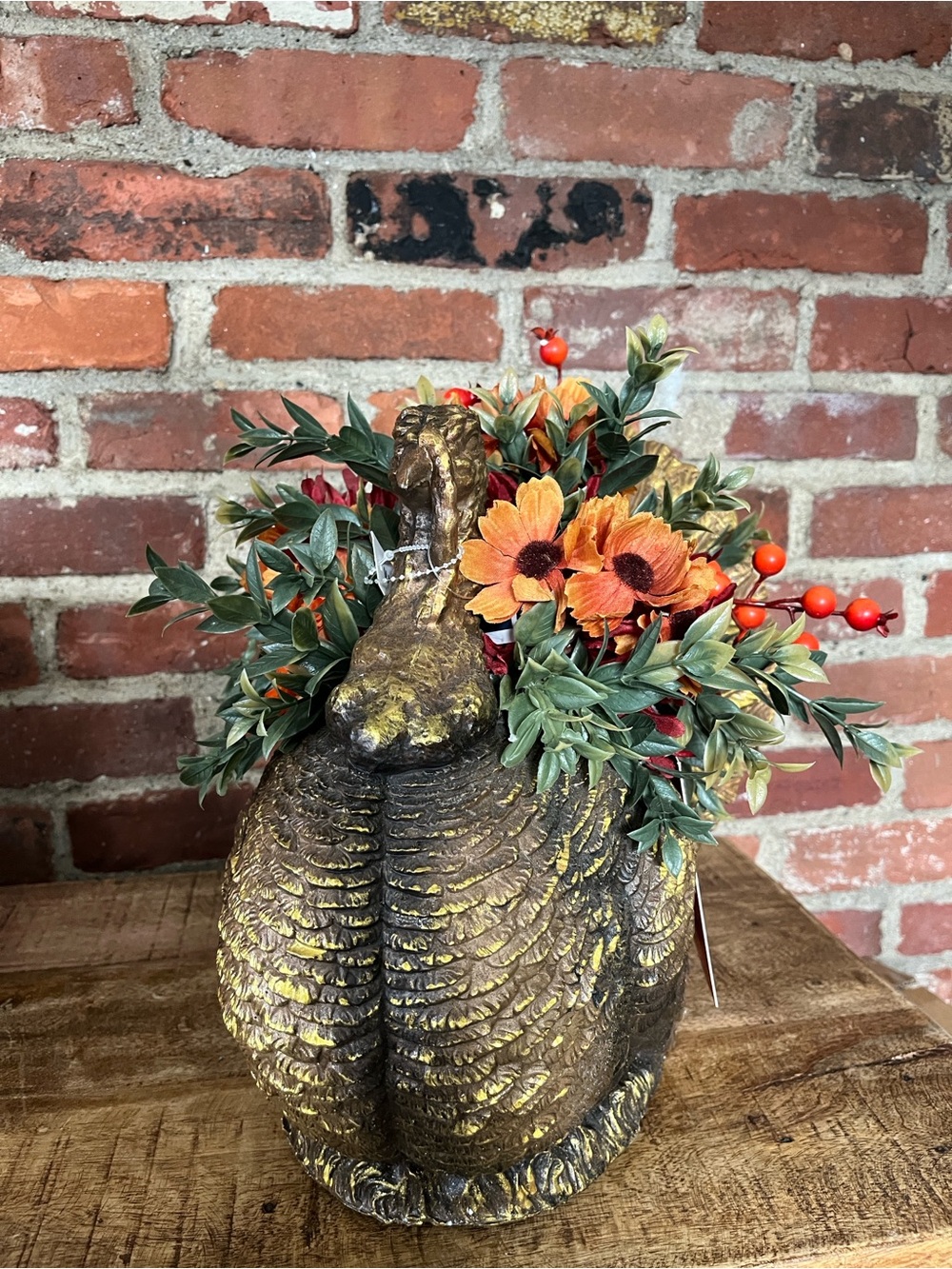 Martha Stewart Gold Turkey arrangement with Orange Flowers and Red Berries